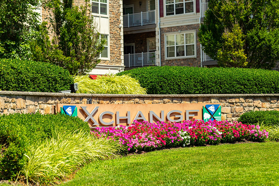 Landscaped entryway with native flowers and bushes, showcasing ecological landscaping solutions for businesses