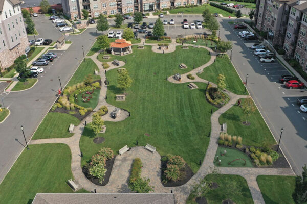 An aerial view of a landscaped park with walking paths, benches, and parking, highlighting landscaping contractor bid evaluation.