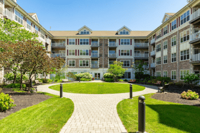 Frontal view of apartment complex with circle walkway