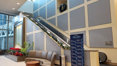 Escalator with foliage decor on handrail