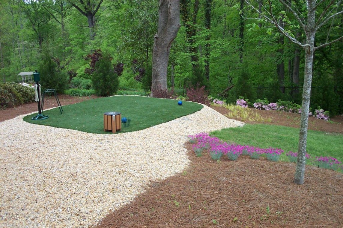 A custom made putting green on a well landscaped property 